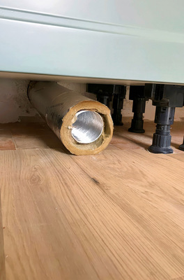 Warmluftaustritt im Sockelbereich der Küchenzeile (links) und mit installierter Sockelblende und Luftgitter.