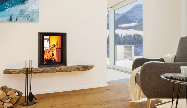 Drinnen feuert der Ofen, draußen liefert die Wärmepumpe Energie.